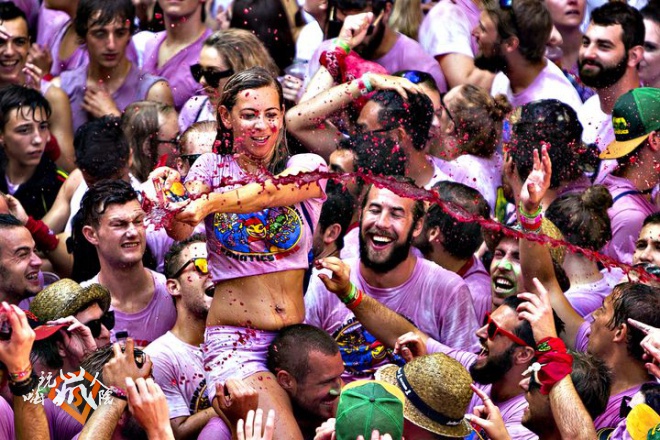 A reveler throws wine during the launch of the 'Chupinazo' rocke